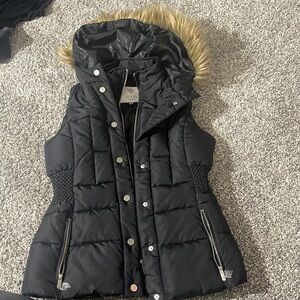 Black zip up puffer vest with faux fur hood